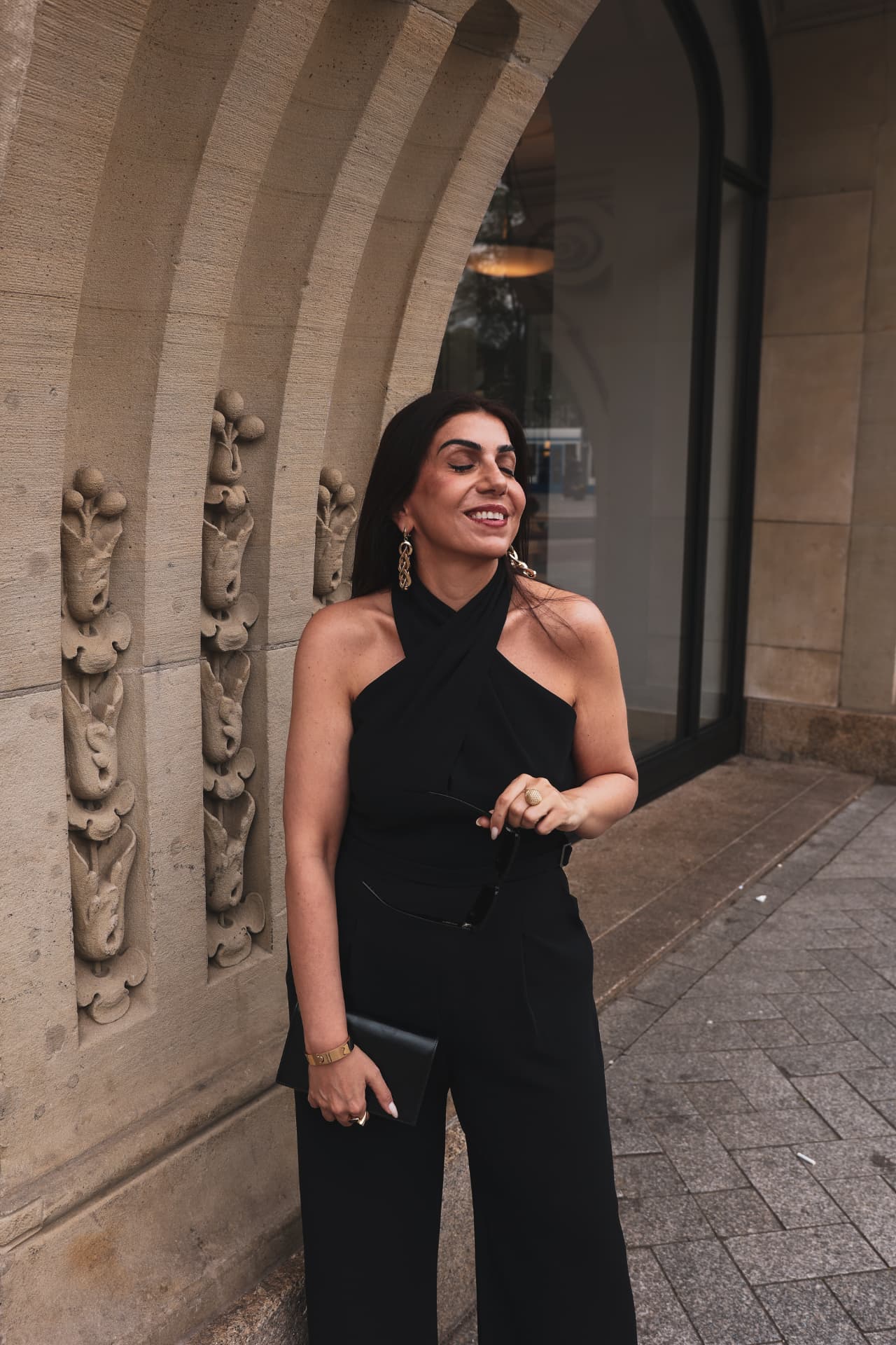 Portrait of Hatice Tekin, eyes closed with a joyful smile, gold jewellery